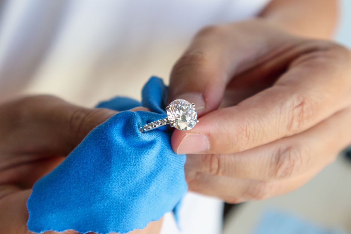 A guy cleaning a wedding ring