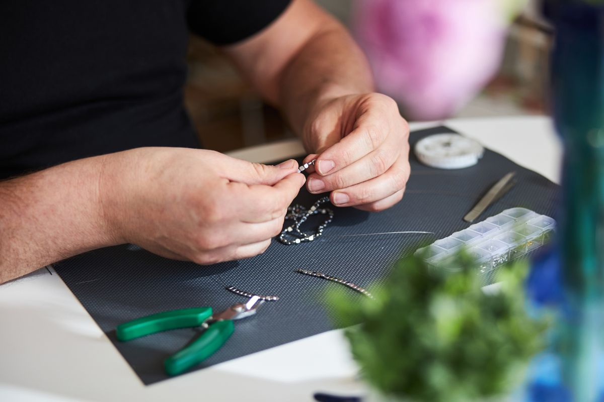 A guy fixing necklace clasp