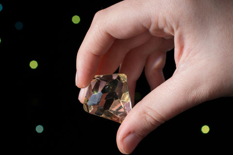 A guy holding fake diamond in his hand