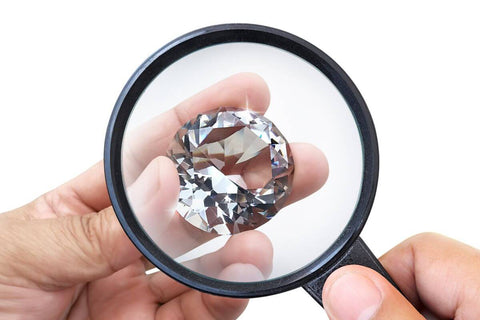 A guy looking at diamond size 