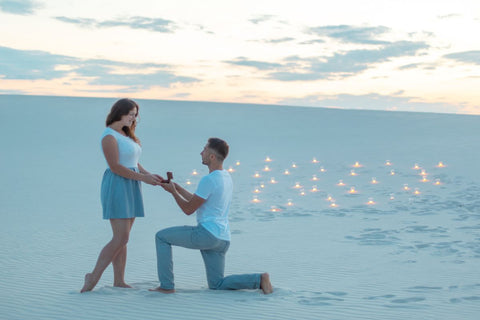 A guy proposing to his girlfriend outdoors