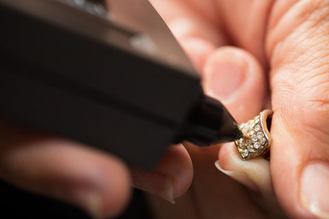 A guy testing diamond ring with the diamond tester