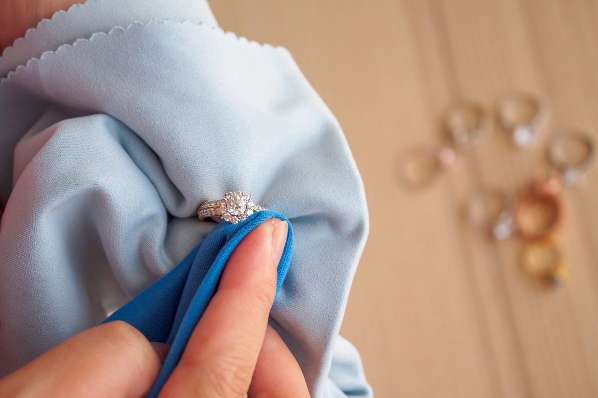 A lady cleaning her diamond ring for more brilliance.