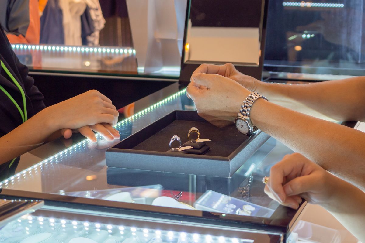 A lady trying customized diamond ring at store.