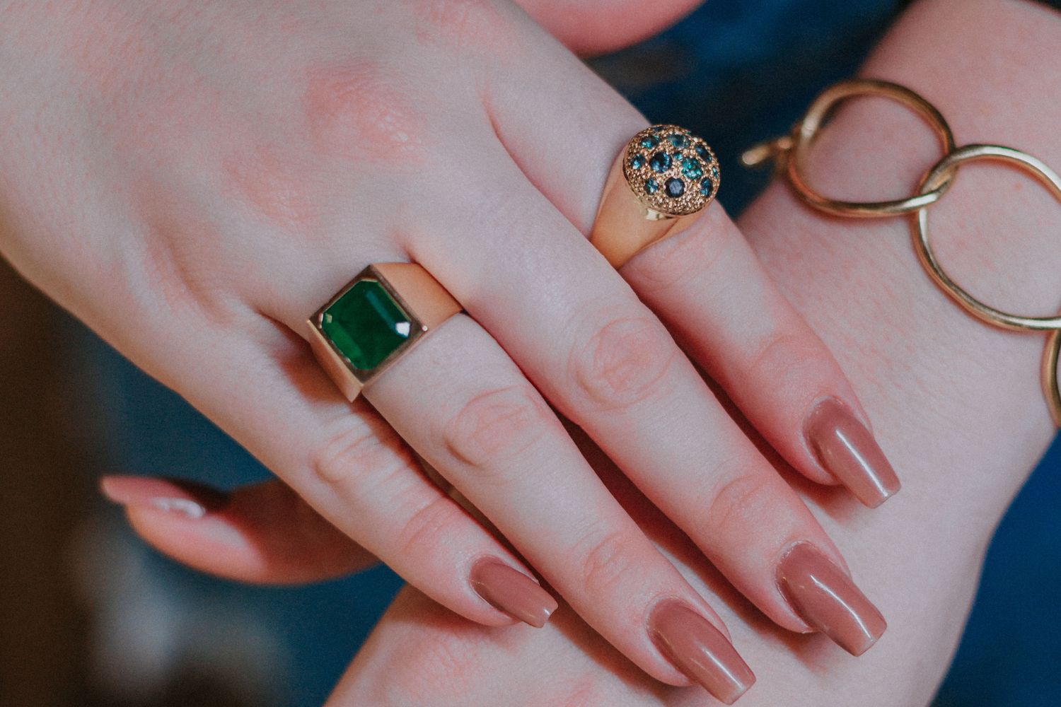 A lady wearing a modern promise ring and an engagement ring