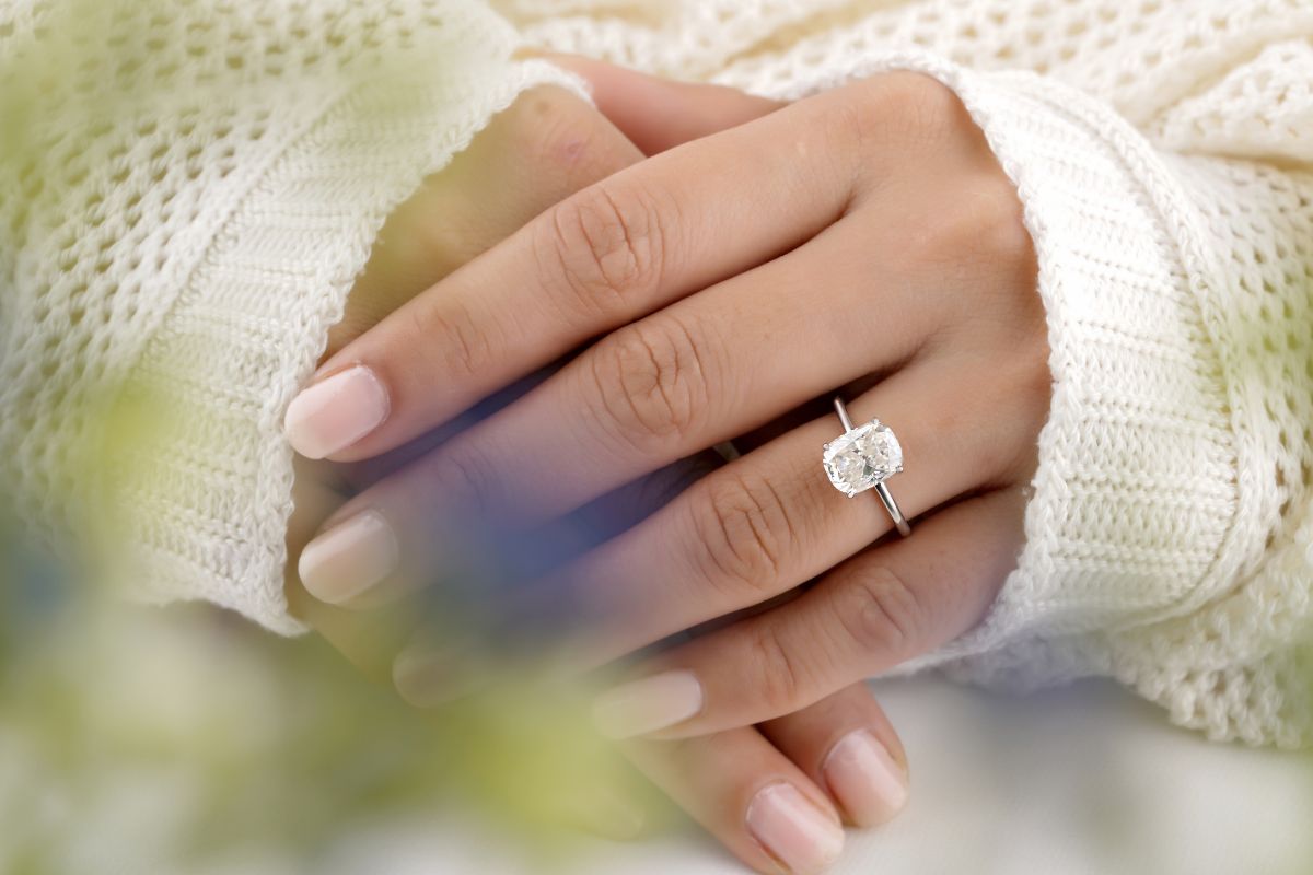 A lady wearing beautiful asscher cut diamond ring.