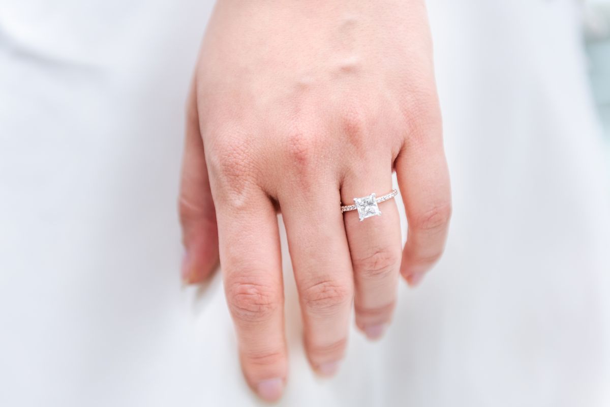 A lady wearing elegant princess cut diamond ring