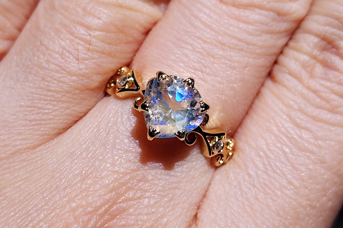 A lady wearing her birthstone moonstone ring.