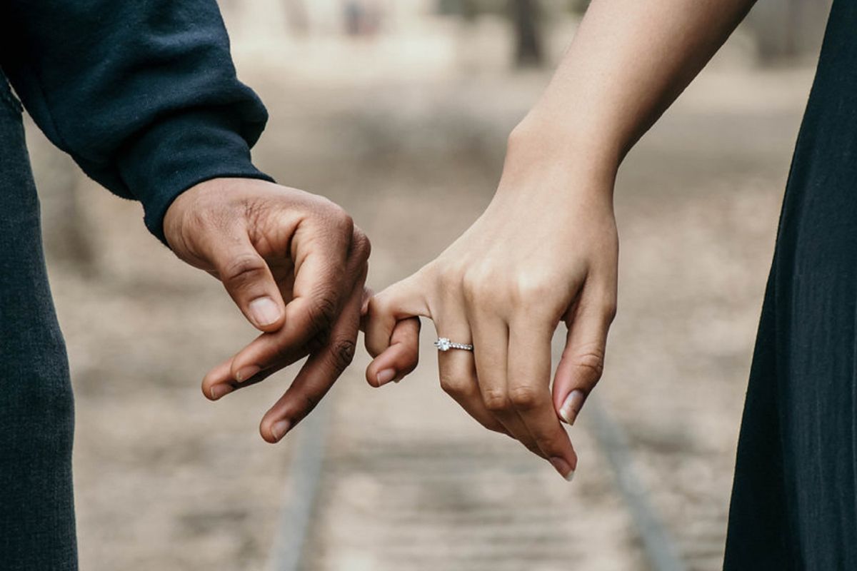 A lady wearing promise ring on the right hand celebrating relation of trust