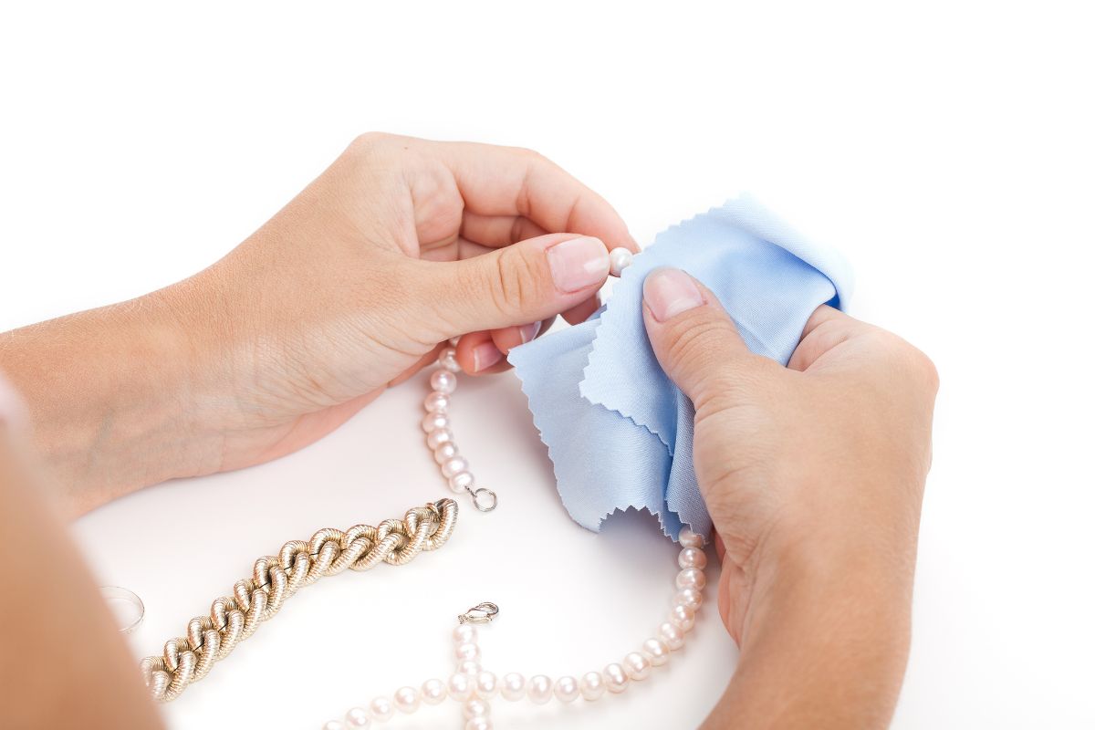 A mother of the bride cleaning her jewelry to be used in her daughter marriage.