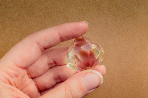 A woman holding a fake diamond in her hand