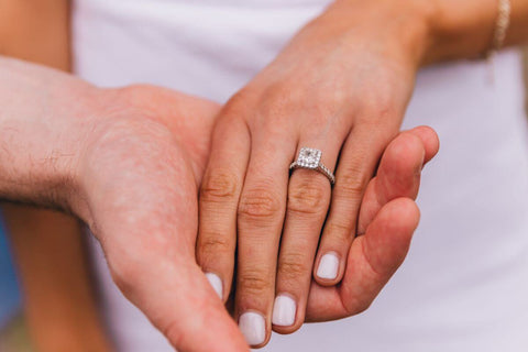 A woman's hand wearing a diamond ring