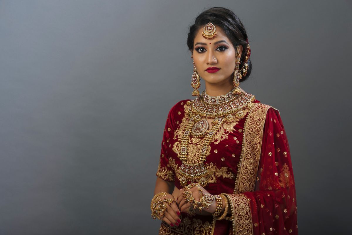 An Indian bride showing her beautiful miligrain jewelry during her wedding.