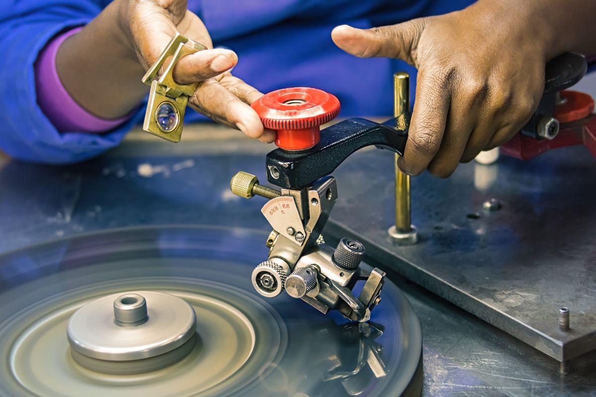 An expert crafting diamond for the favourable shapes with the help of machine.