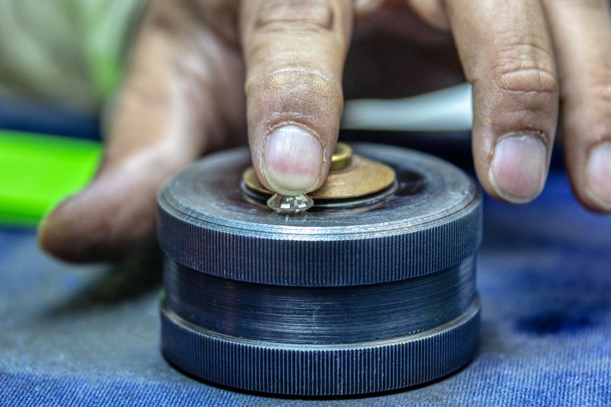 An expert polishing diamond with great attention