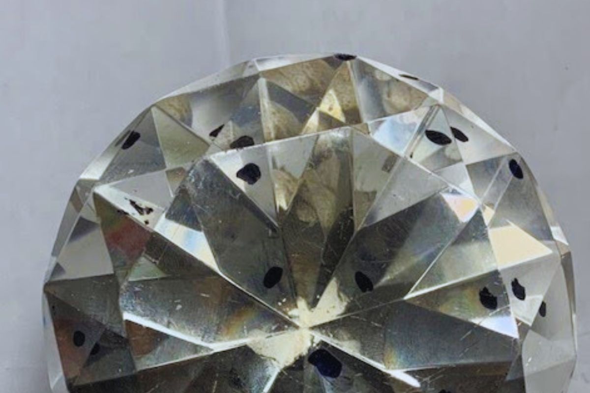 Black dots on a diamond close up view