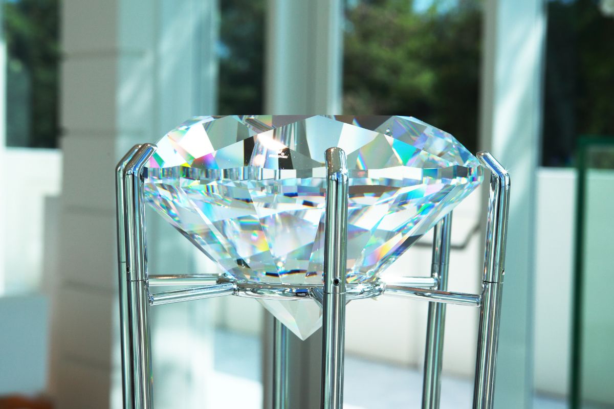 Diamond kept on a holder showing its brilliance in the day light.