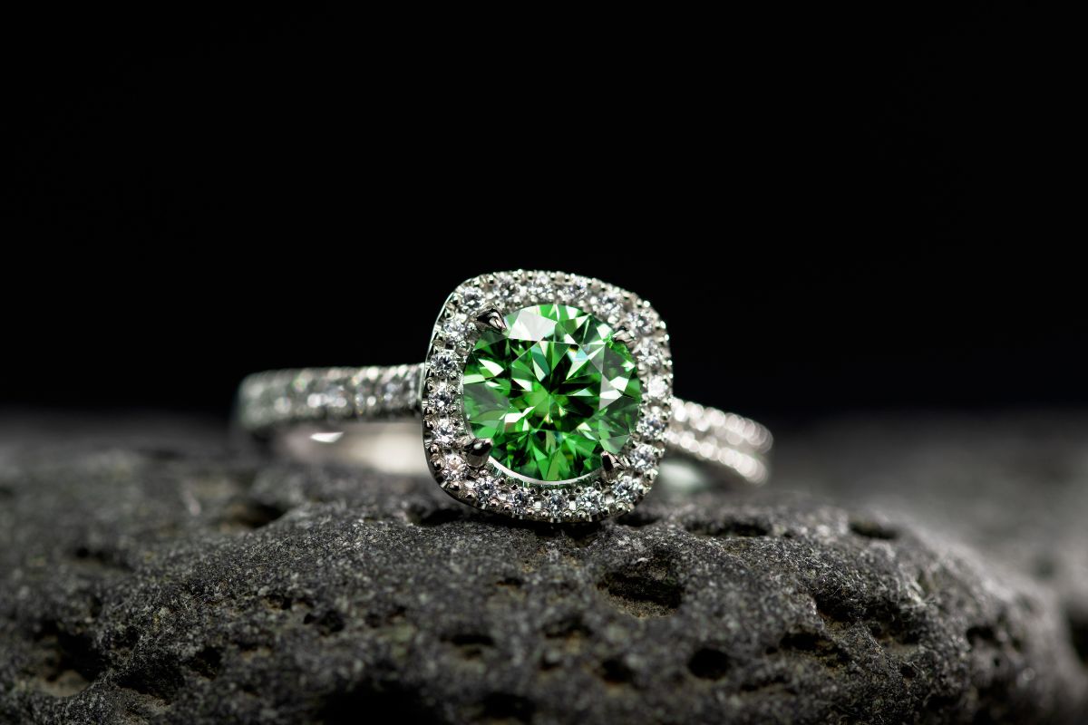 Emerald gemstone inside a diamond ring