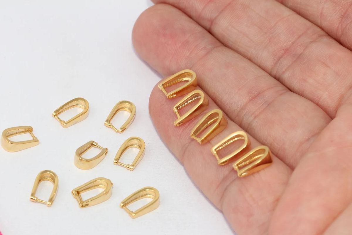 Gold pinch bails for jewelry.