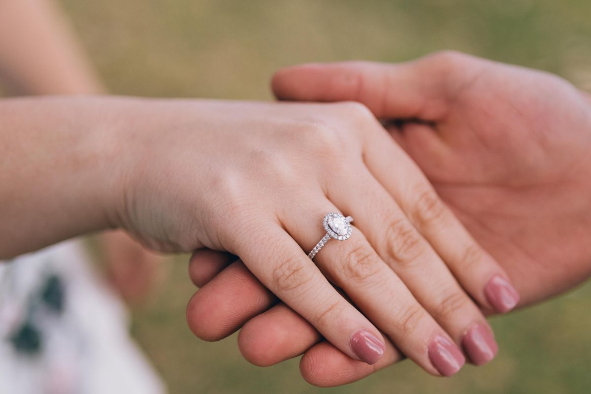 Lady wearing engagement ring on the right hand's ring finger