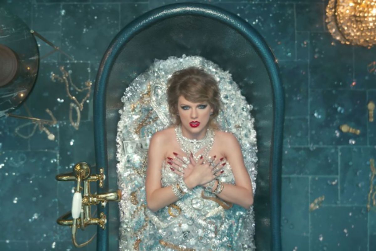 Taylor swift recording for her music video surrounded by the diamond jewelry.