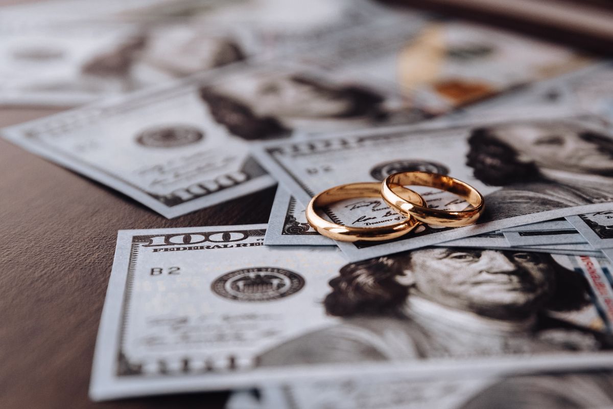 Two engagement ring kept with each other on the money showing it has good monetary value