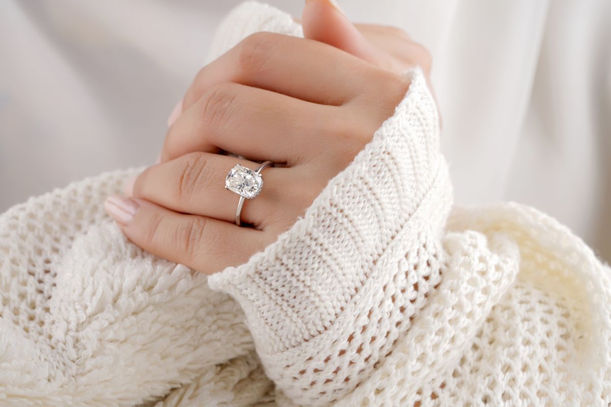 Wearing Cushion brilliant diamond ring in hand