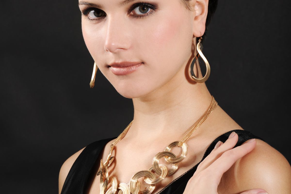 Woman wearing gold vermeil necklace and earrings