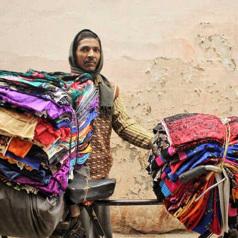 Seller with sari on bicycle