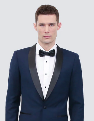 Photo of man wearing black tuxedo with black bow tie.