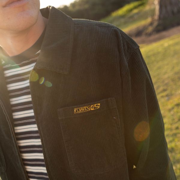 Man wearing rusty corduroy jacket with stripe tee | Shop Mens Corduroy