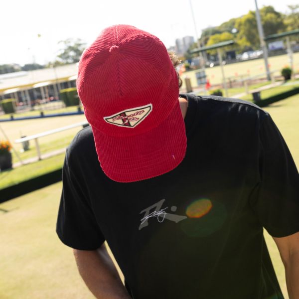 Man wearing red rusty corduroy hat and rusty black tee | Shop Mens Corduroy