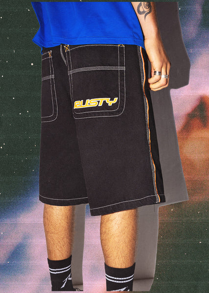 Man wearing Rusty Australia Flip Daddy Draggin jort in black with space background