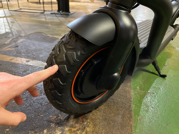 Reviewer with tyres on Navee N65 electric scooter