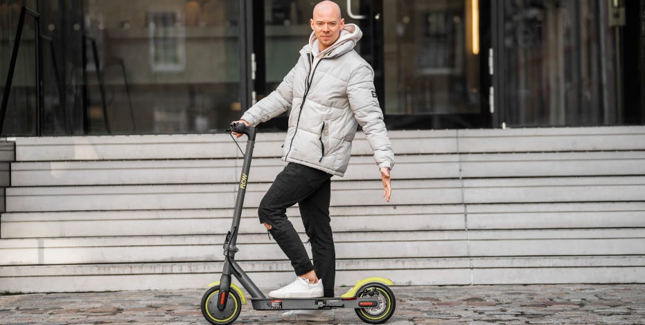 Person standing next to an electric scooter