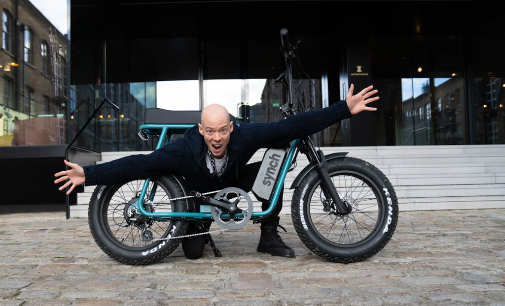 A person climbing through an electric bike's frame