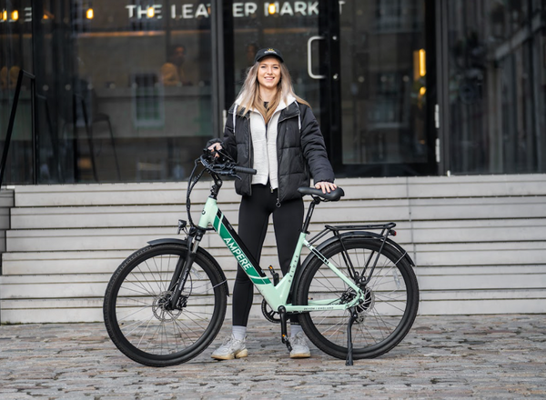 Girl standing with Ampere Deluxe Step Through electric bike