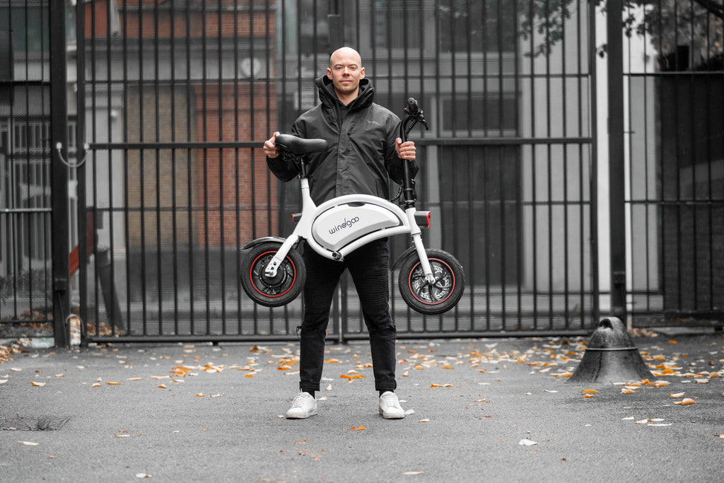 Person holding a Windgoo B3 electric bike