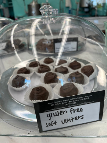 gluten-free chocolates are under dome in white cups to keep them separate 