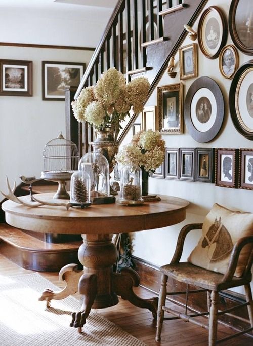 Love the use of this table as an entry table, gallery wall on the staircase... love everything about this picture.