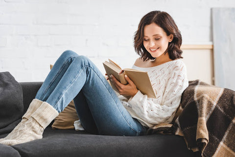 Young woman reading on a couch