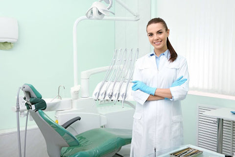 dentist standing in her office with arms crossed