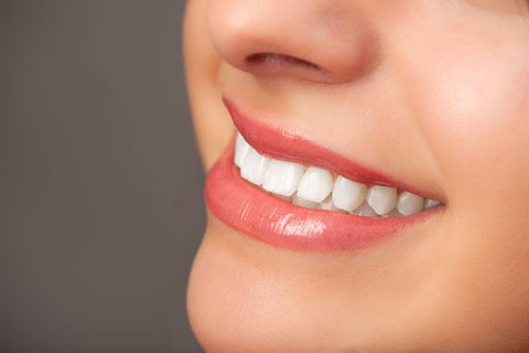 closeup of a young woman's beautiful smile with straight white teeth