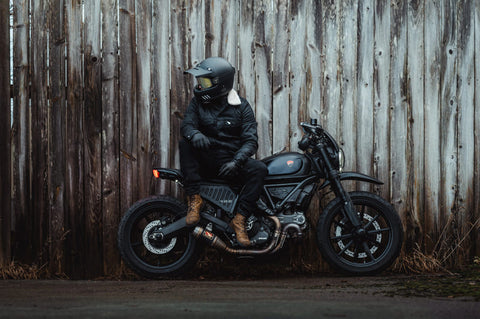 biker leaning against fence