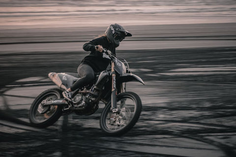 girl riding through mud