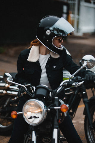 girl sitting on motorbike with sunglasses