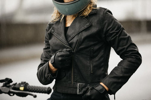 girl zipping up motorcycle jacket