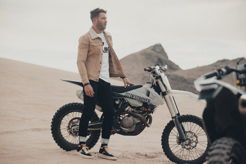 rider standing next to bike