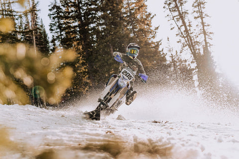 man riding a motorbike in cold snowy weather