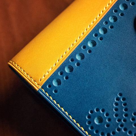 details of brogue styled buttero leather passport holder